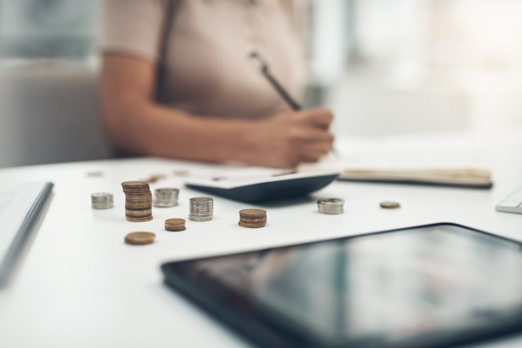 Closeup shot of an unrecognisable businesswoman calculating finances in an office