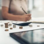 Closeup shot of an unrecognisable businesswoman calculating finances in an office